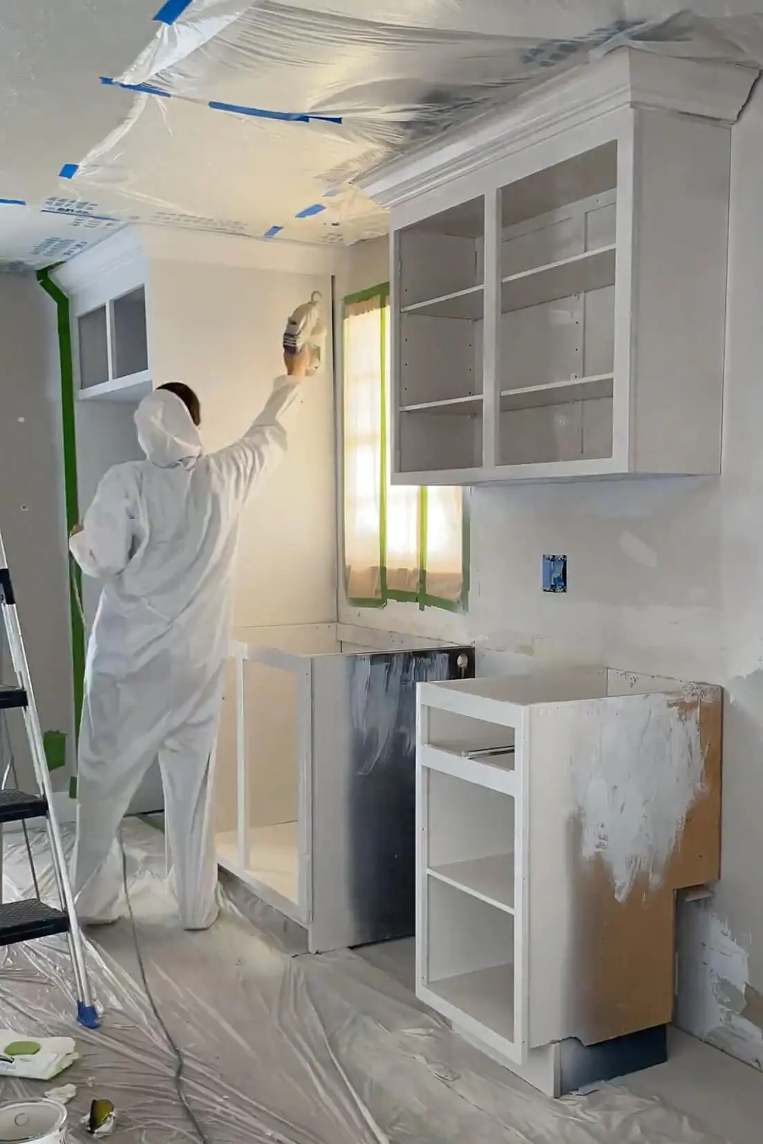 Priming and painting the inside and outside of kitchen cabinets. 